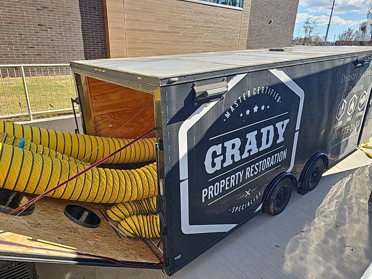 Grady Property Restoration trailer-mounted drying system with ducting deployed at a commercial water damage loss.